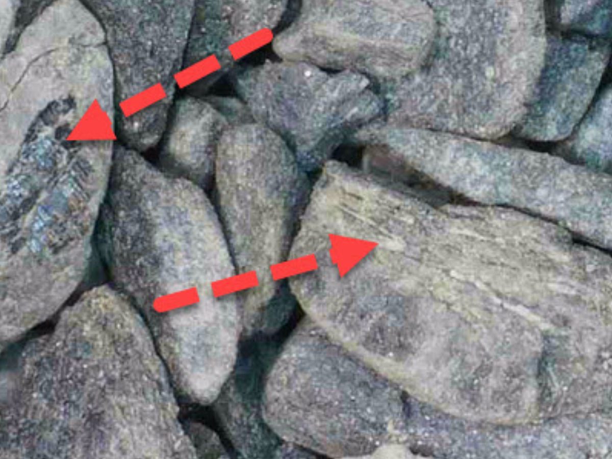 A pile of rocks with red arrows pointing to the top.