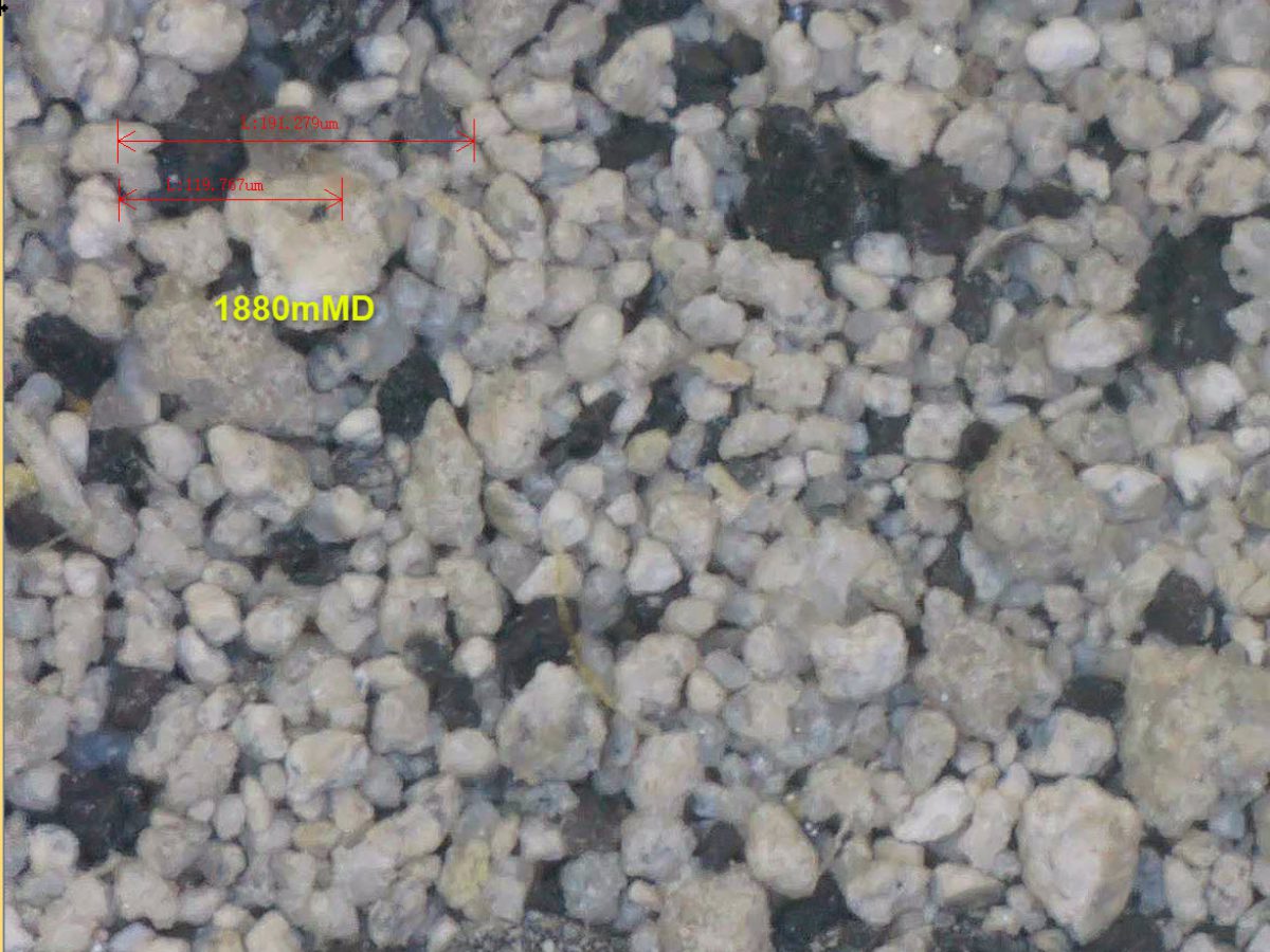 A close up of some rocks with a yellow dot on it