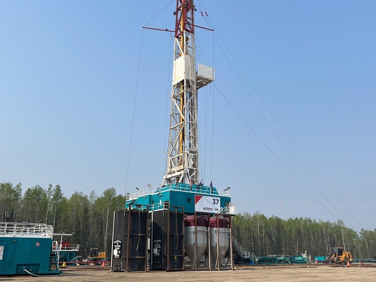 A drilling rig with trees in the background.