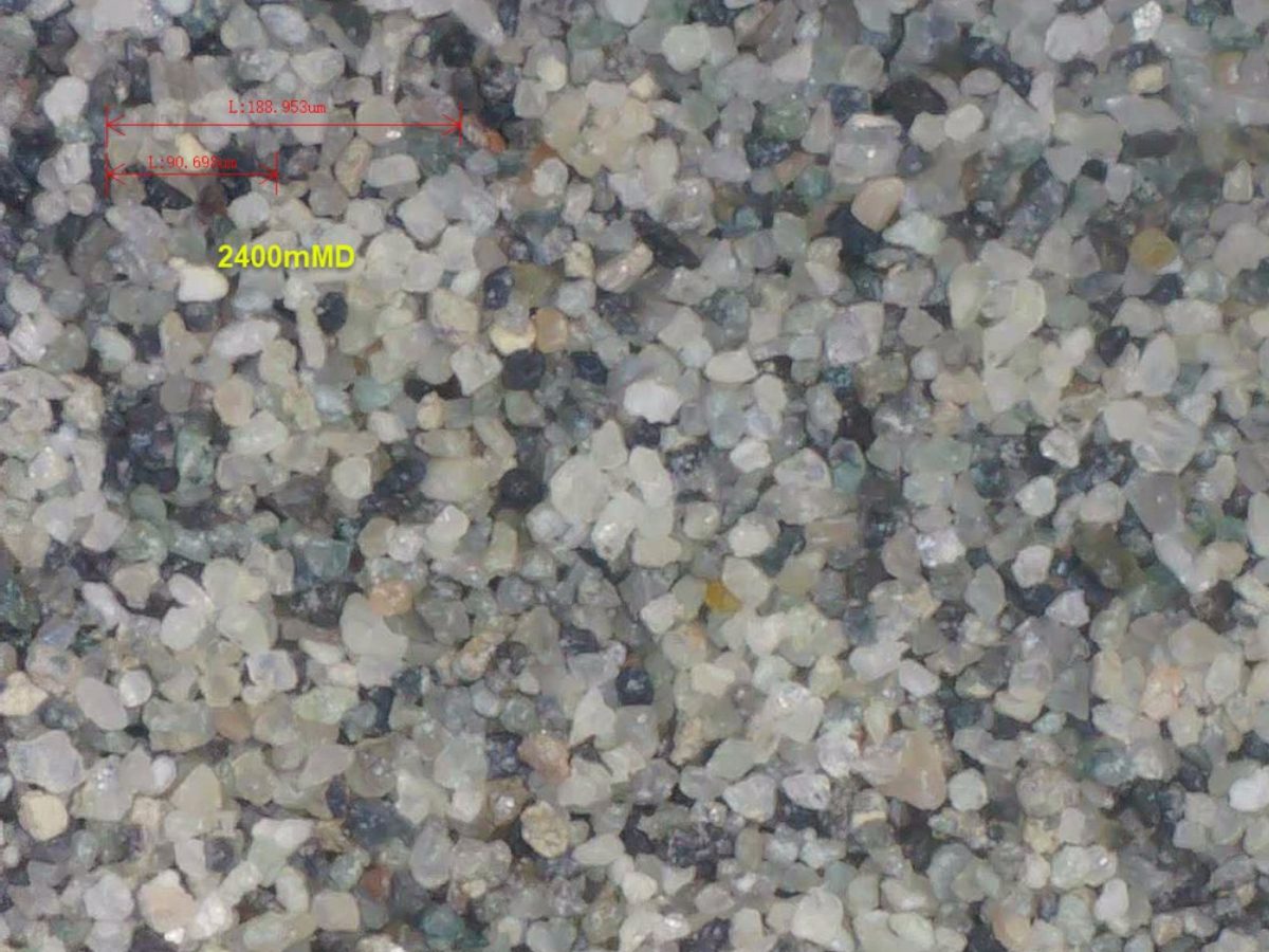 A close up of some rocks in the sand